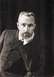 https://upload.wikimedia.org/wikipedia/commons/thumb/d/db/Pierre_Curie_by_Dujardin_c1906.jpg/110px-Pierre_Curie_by_Dujardin_c1906.jpg